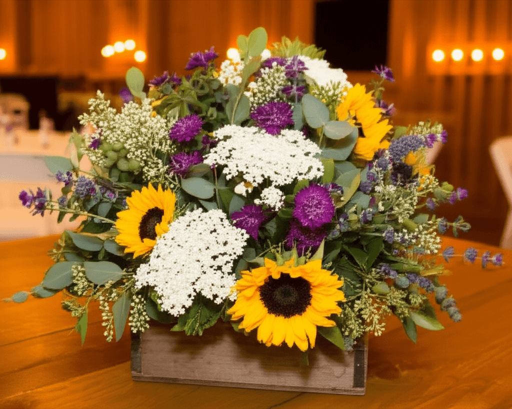 Lush rustic wedding floral arrangement with wildflowers and eucalyptus in a wooden box